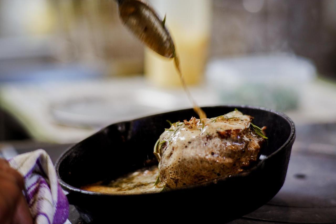 Parehua Resort Martinborough Exteriör bild A chef pouring sauce over a steak